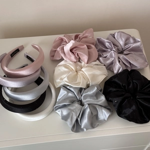 Detail of satin hair scrunchies and sponge headbands set in various elegant colors
