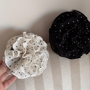 Detailed view of polka dot pleated chiffon hair scrunchies in black and white styles
