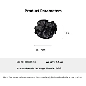 Detail view of black and white plaid scrunchie showing 16cm dimensions and fabric texture