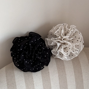 Detailed close-up of French-style ruffled hair scrunchies with elegant polka dot patterns