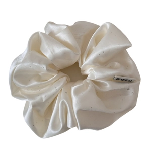 Elegant cream satin hair scrunchie with silver glitter details and premium silk texture