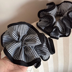Large black and white checkered scrunchies with pleated ruffle edges and elastic hair band