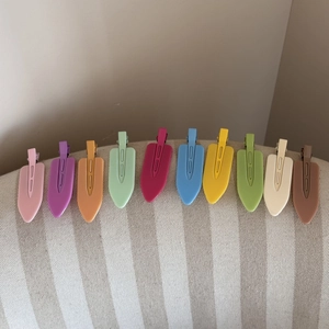 Set of 10 colorful matte hair clips in various dopamine colors arranged on fabric