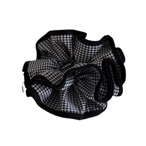 Chic black and white gingham scrunchie with ruffled edges and soft fabric texture