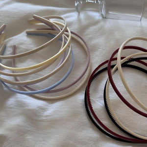 Detailed close-up of colorful non-slip headbands with teeth on soft white fabric base