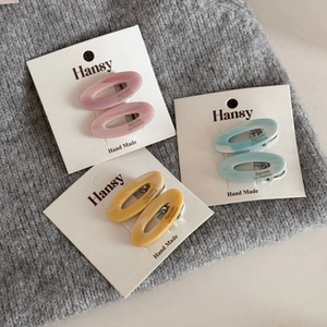 Three pairs of elegant oval acetate hair clips in pink blue and yellow with marble texture