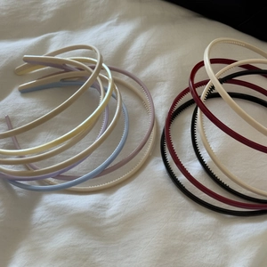 Detail showing various candy-colored non-slip headbands with inner teeth on white cloth