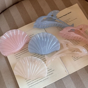 Detail of dolphin and shell hair claws in jelly pink, blue and pearlescent finishes