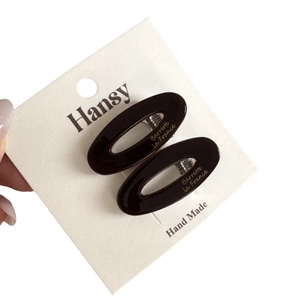 Pair of oval dark coffee acetate hair clips with Barrette La France gold lettering