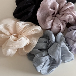 Elegant satin fabric scrunchies in multiple soft colors with glossy textured finish