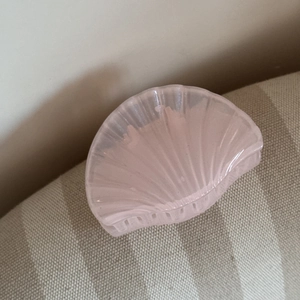 Detailed macro view of pink translucent resin hair claw clip in a bionic shell design