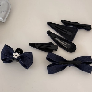 Détail de l'ensemble de barrettes noeud en denim bleu foncé avec des touches florales
