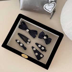 Détail d'un ensemble de 6 accessoires cheveux en denim bleu avec fleurs dans un coffret