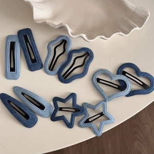 Denim fabric hair clip set featuring stars and hearts shapes in blue shades for girls