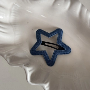 Star-shaped denim fabric BB clip with detailed stitching and black metal snap fastener