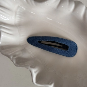 Close-up of denim fabric BB hair clip showing blue weave texture and teardrop shape