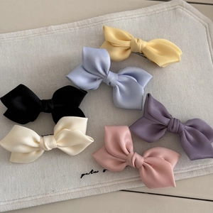 Set of six colorful satin bow hair clips in pastel tones for elegant women's styling