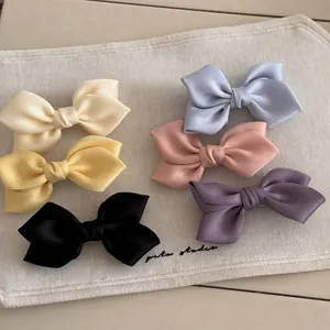 Set of six colorful satin bow hair clips in pastel colors with handmade silk texture