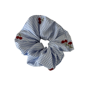 Blue gingham scrunchie with red cherry embroidery pattern for sweet hair styling