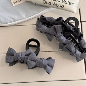 Dark grey fabric bow hair claw clips in two sizes for elegant half-up hairstyles