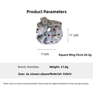 Detailed view of blue plaid scrunchie with strawberry print, size 17cm and fabric material