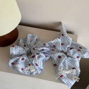 Blue plaid scrunchie set with red strawberry print and white lace trim detail