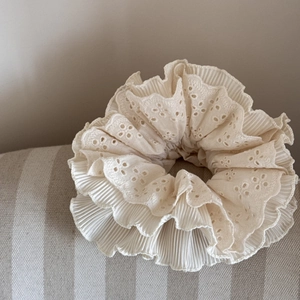 Detail shot of multi-layer beige lace scrunchie with intricate geometric hollow embroidery