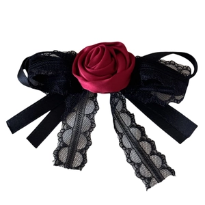 Gothic dark rose hair clip with black lace bow and long tassel streamers on white background