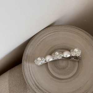 Détails de perles baroques et de perles de cristal sur une pince à cheveux argentée