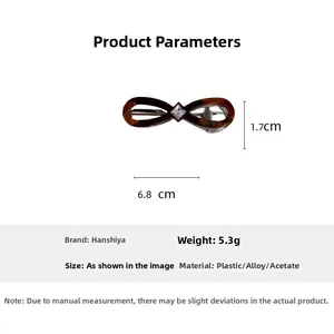 Detail view of acetate infinity hair clip with tortoiseshell pattern and square rhinestone