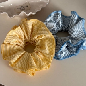 Close-up of colorful striped scrunchies showing fine fabric texture and neat sewing detail