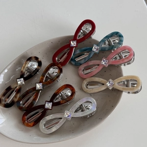 Bow-shaped acetate hair clips set of 8 in assorted colors with square rhinestone accents