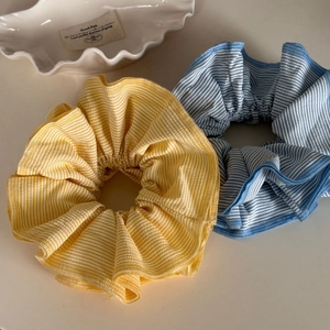 Colorful striped dopamine style large hair scrunchies in bright yellow and light blue colors