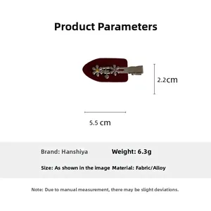 Detailed view of dark red flower hair clip with silver alloy accents and rhinestones