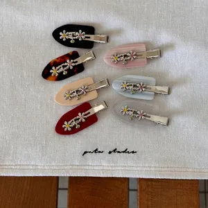 Seven-piece floral metal hair clip set with colorful rhinestones on acetate duckbill clips