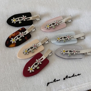 Floral hair clips set with silver metal flowers and colorful rhinestones on duckbill clips