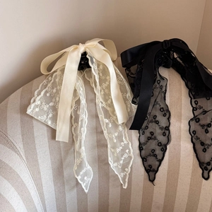 Detailed embroidery on French lace bow hair clips in elegant cream and black shades