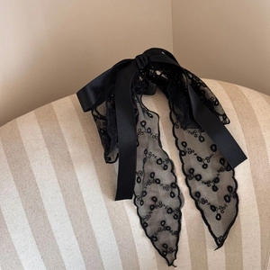Detailed view of elegant black lace ribbon bow hair claw clip with floral embroidery