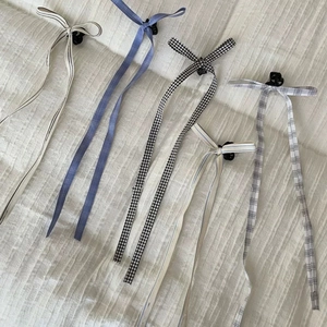 Ballet style ribbon hair clips featuring long striped and plaid fabric bow streamers
