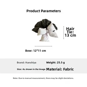 Detail view of a 13cm oversized fabric scrunchie with a 12cm purple padded bow