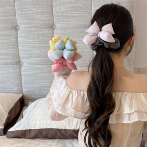 Colorful pastel bow scrunchie set for women in a cozy bedroom setting for daily hairstyling