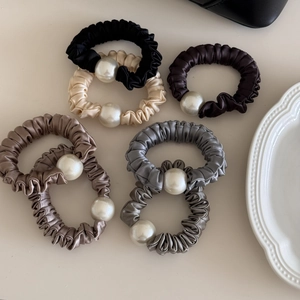 Elegant satin hair scrunchies set with pearl accents in assorted neutral colors
