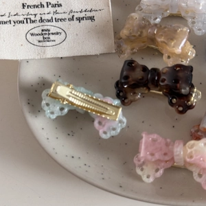Elegant acetate hollow bow hair clips in multiple colors with metallic duckbill grip