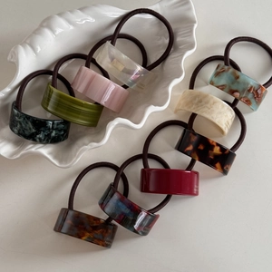 Detail of colorful acetate geometric hair ties with tortoiseshell and marble patterns
