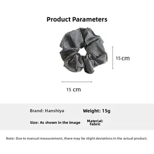 Detail shot showing 15cm large black and white checkered fabric hair scrunchie dimensions