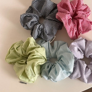 Detailed set of five plaid gingham scrunchies in diverse pastel colors and soft cotton fabric