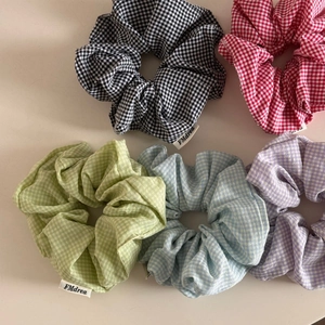 Detailed view of colorful checkered plaid oversized scrunchies set in five pastel colors