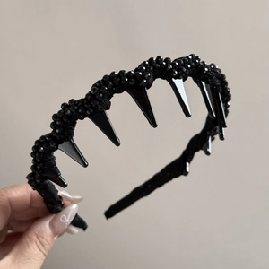 Détail du serre-tête ondulé noir avec dents antidérapantes et texture perlée