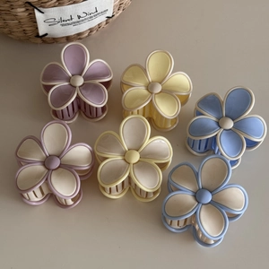 Detailed set of six matte flower hair claws in assorted pastel colors for styling