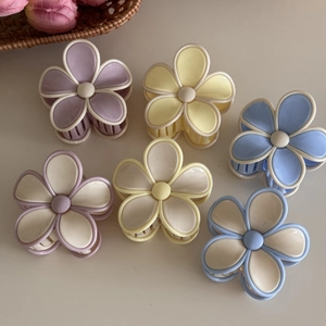 Set of 6 cute matte resin flower hair claws in pastel colors shown on a neutral background